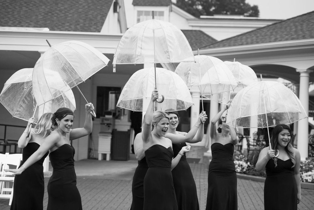 Bridal party dodges raindrops during wedding at Fairlawn Country Club in Akron, Ohio.