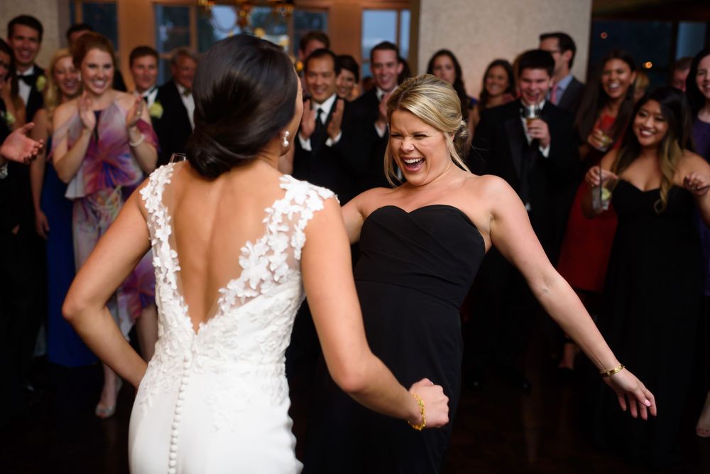 Bride and bridesmaid on dance floor during wedding at Fairlawn Country Club in Akron, Ohio.