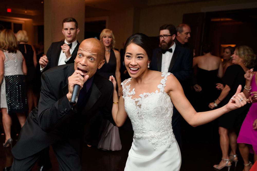 Bride letting loose with singer during wedding reception at Fairlawn Country Club in Akron, Ohio.