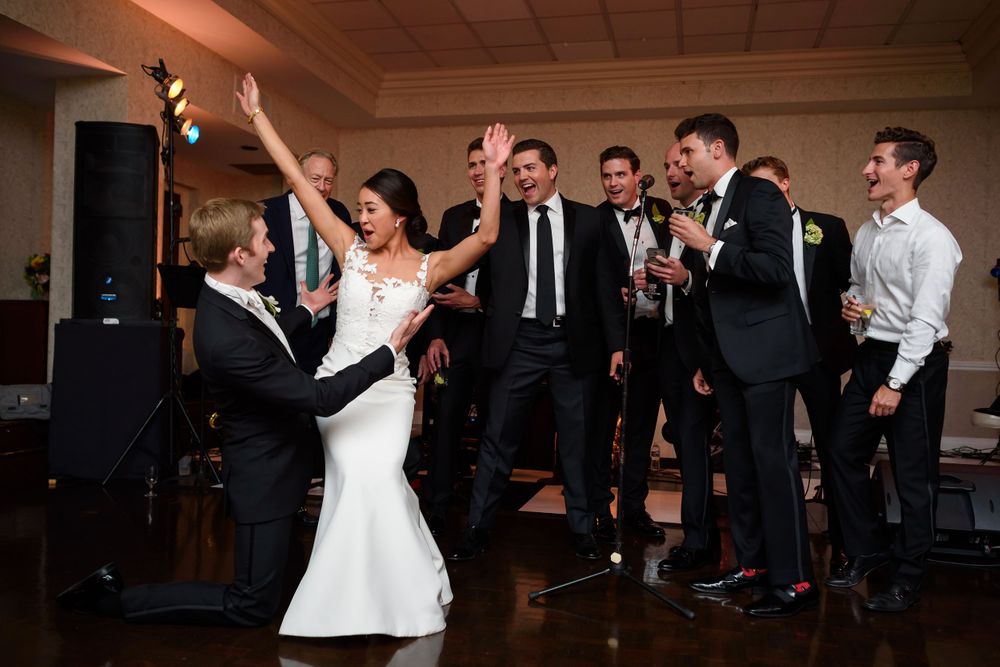 Groom and fraternity brother's serenade bride during wedding reception at Fairlawn Country Club in Akron, Ohio.
