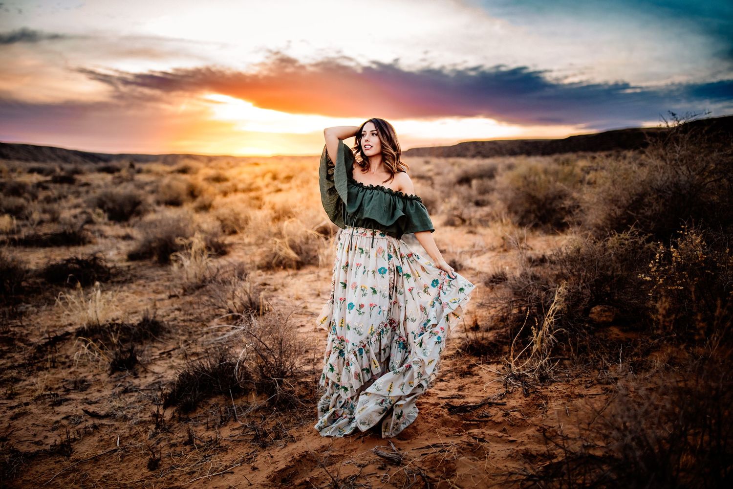 Artistic desert portrait during a dramatic sunset with colorful clouds.