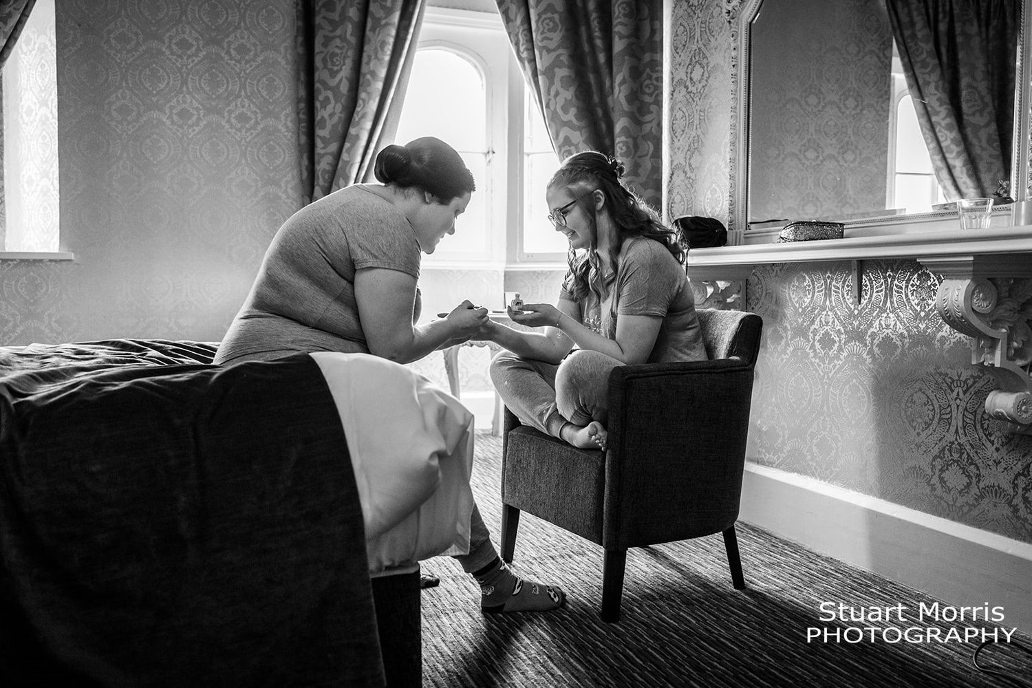 bride and bridesmaid getting ready on the wedding morning. Ruthin castle wedding venue.