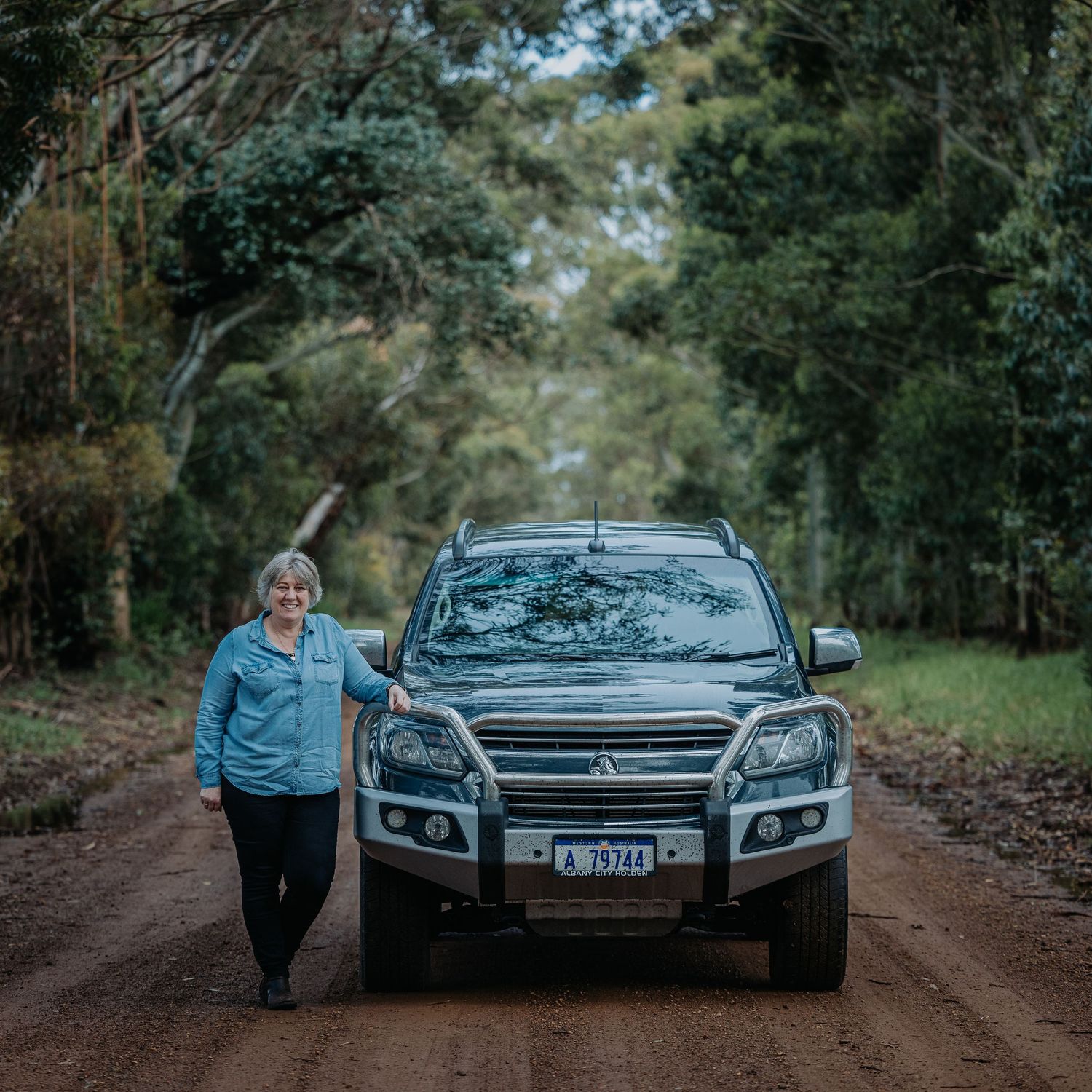 Outdoor automotive photography session on dirt road with SUV.