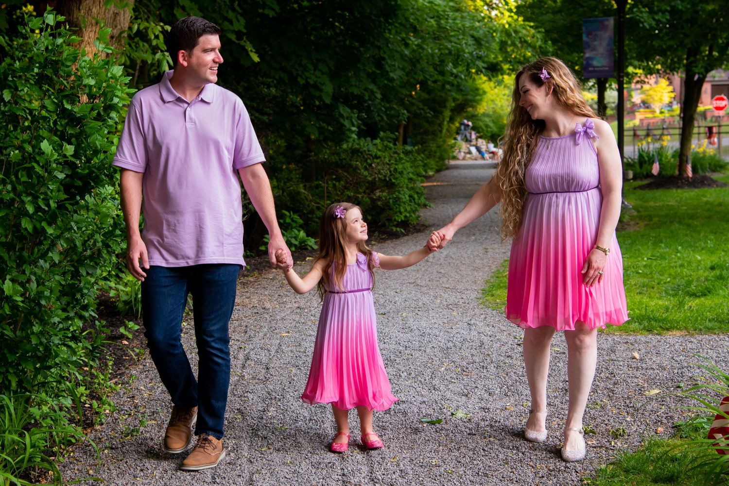 Family photo walking toward camera, girl looking at mom