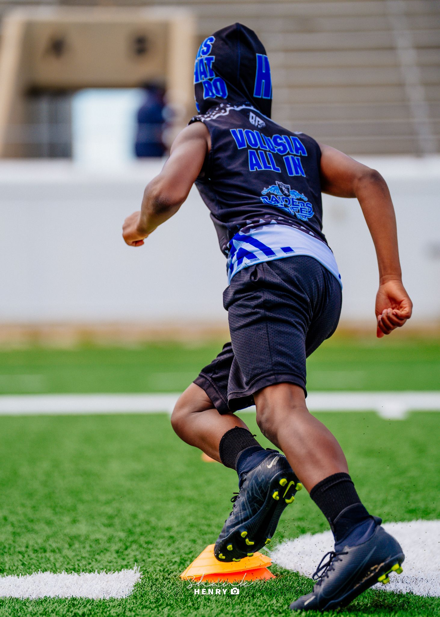 Athletes interacting on a football field during training session.