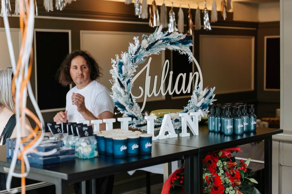 A party setup featuring a Julian name sign decorated with frosted blue branches and white letters.