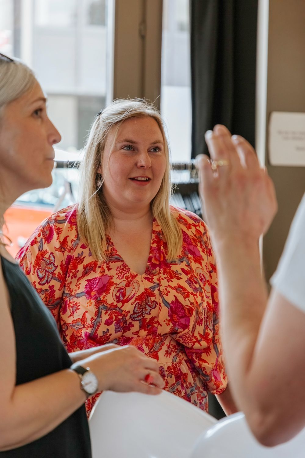 Group having animated discussion in retail environment.