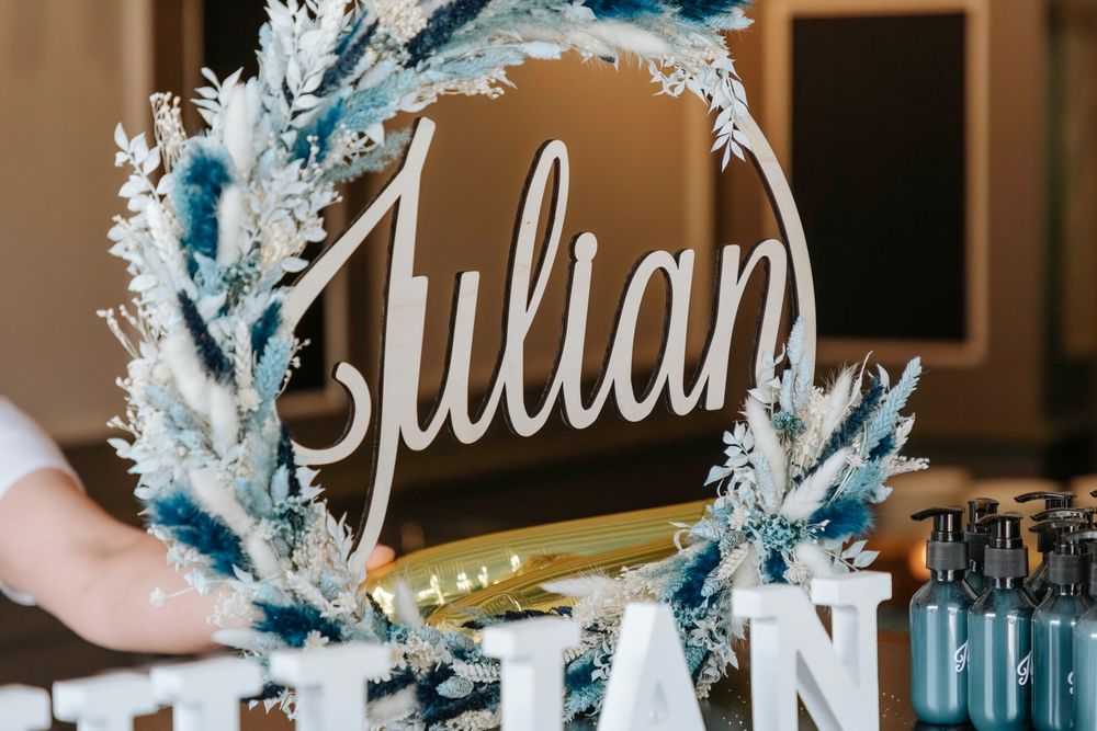 A close-up of a blue and white decorative name wreath spelling out Julian.