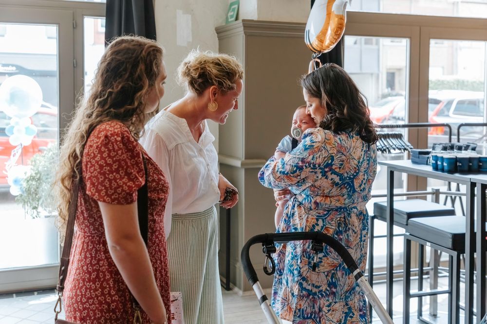Three people having conversation in casual retail space.