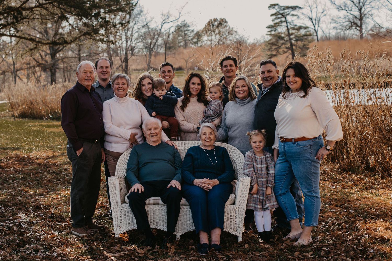 Family group portrait taken outdoors on a sunny autumn day.