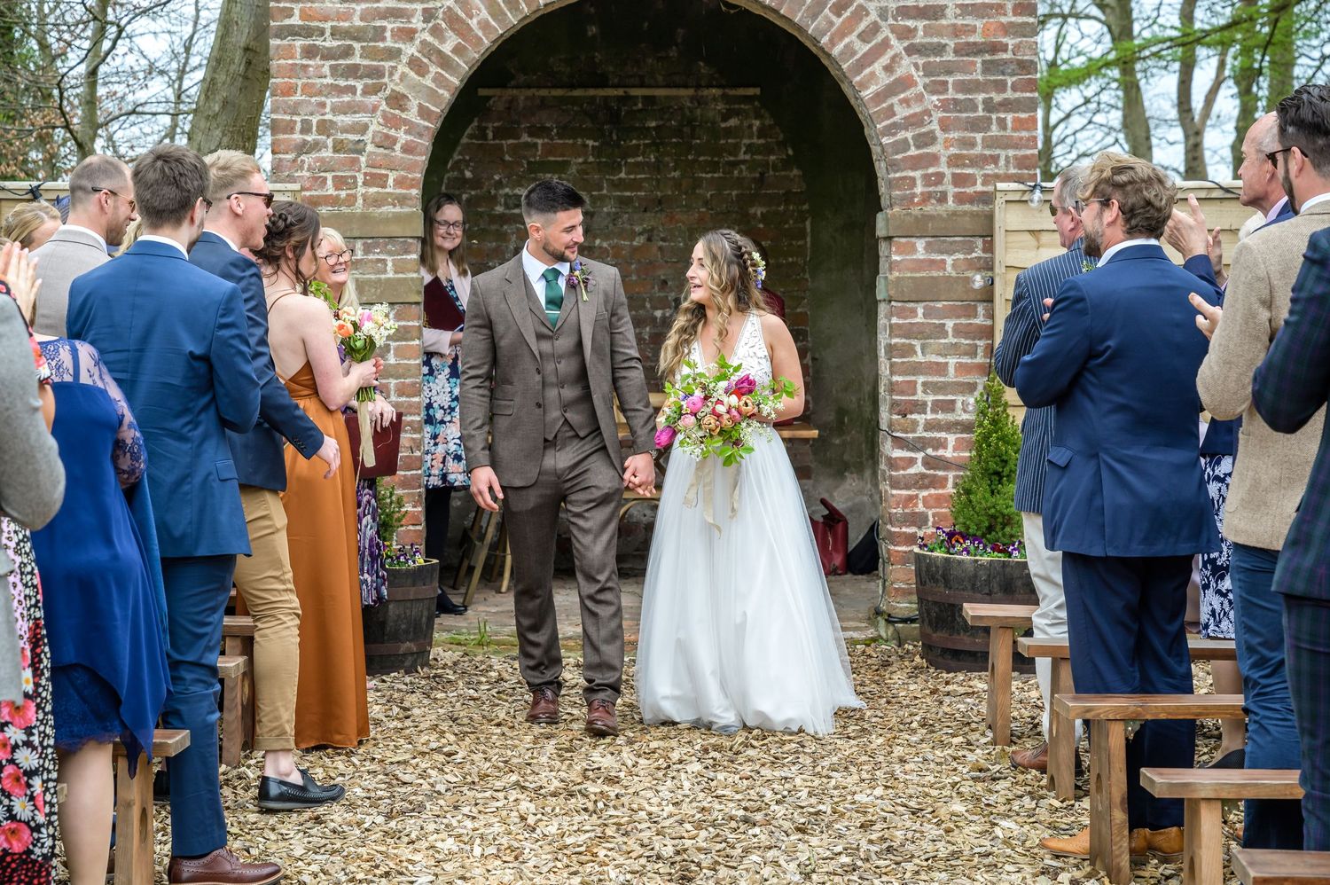 Bride and groom exiting ceremony at Castletown Woodland Weddings