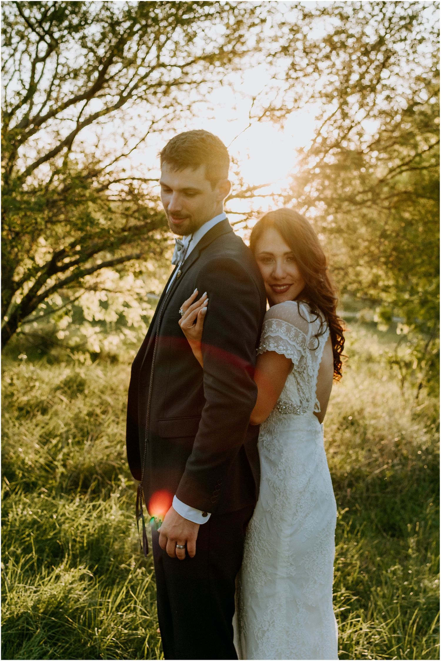 Sunset wedding portrait with natural backlighting creating warm golden atmosphere.