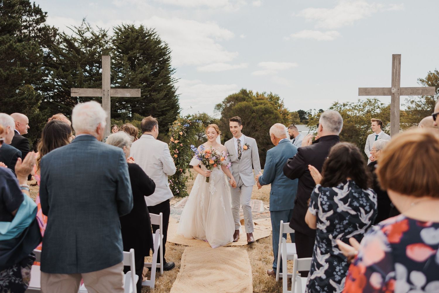 couple bride and groom walking down aisle at wedding ceremony. Chic outdoor wedding
