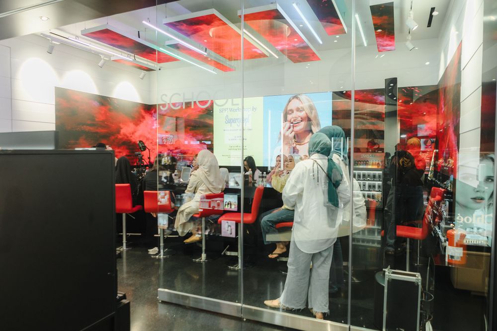 Modern office interior with red lighting and glass partitions.