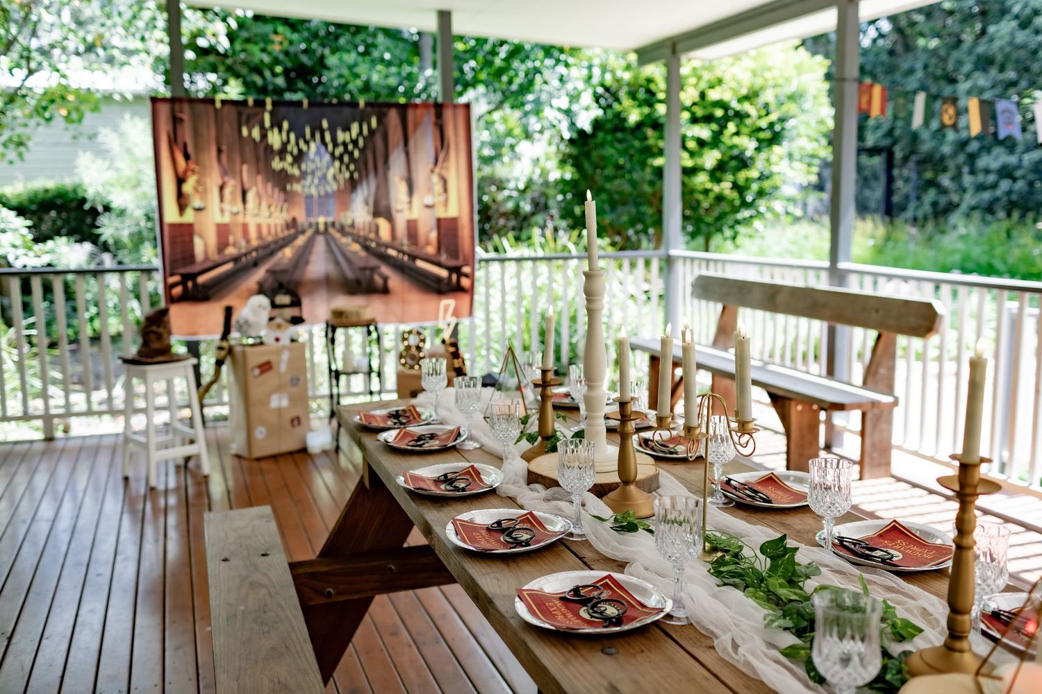 A magical dining setup on a deck with floating candles and Hogwarts Great Hall backdrop.