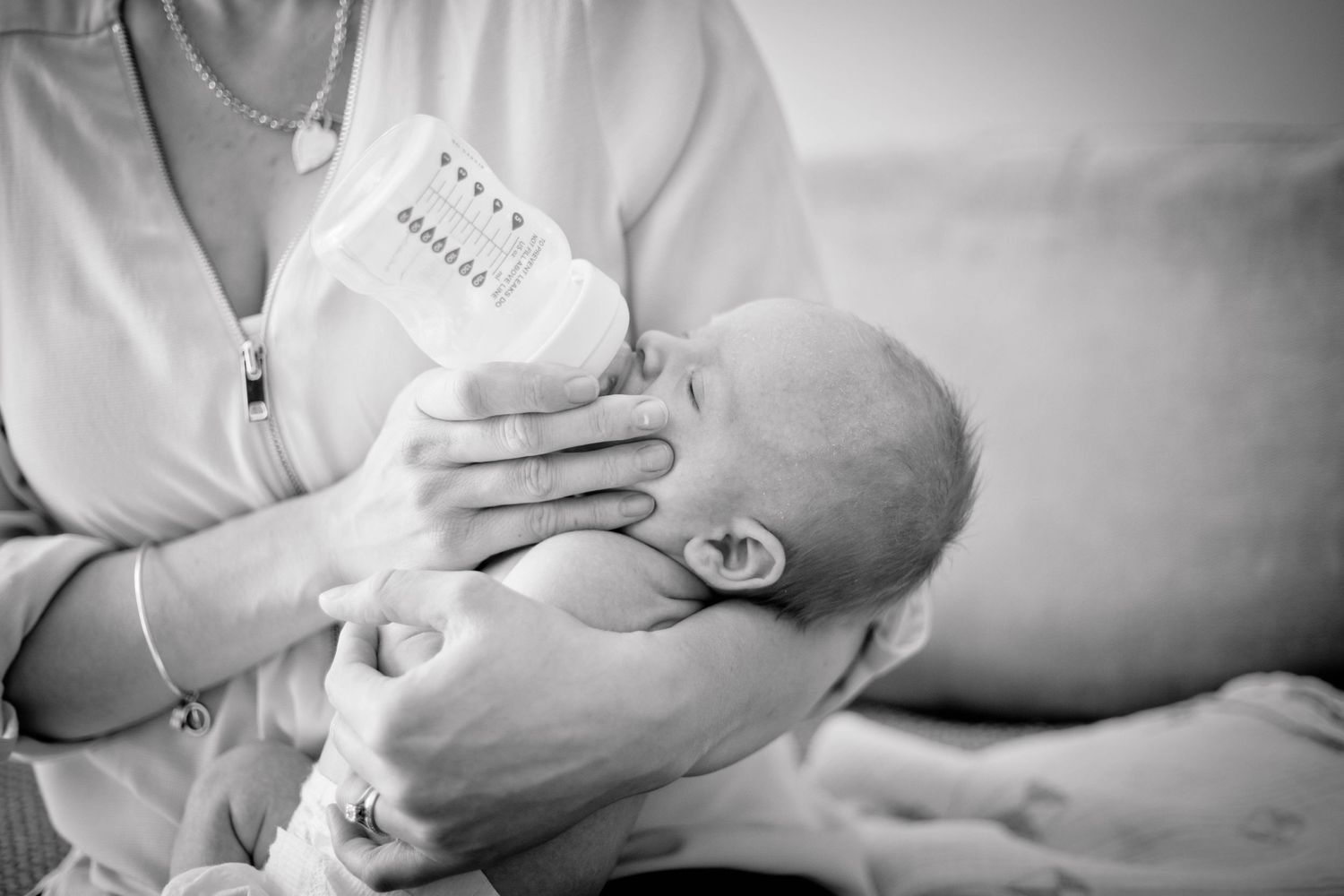 Black and white image of bottle feeding moments.