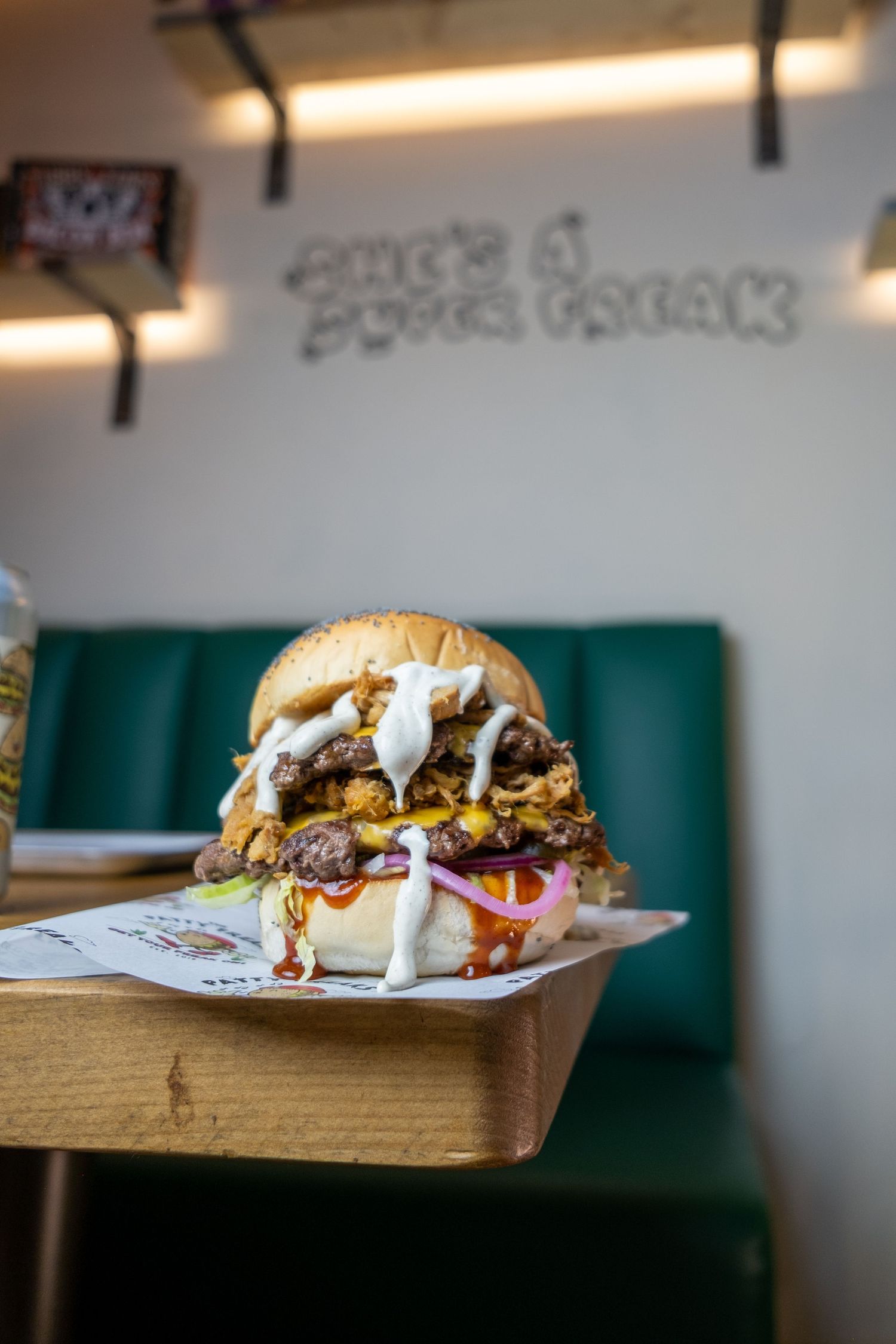 Double smashed burger by the Patty Freaks, with cheese and sauce oozing out.
