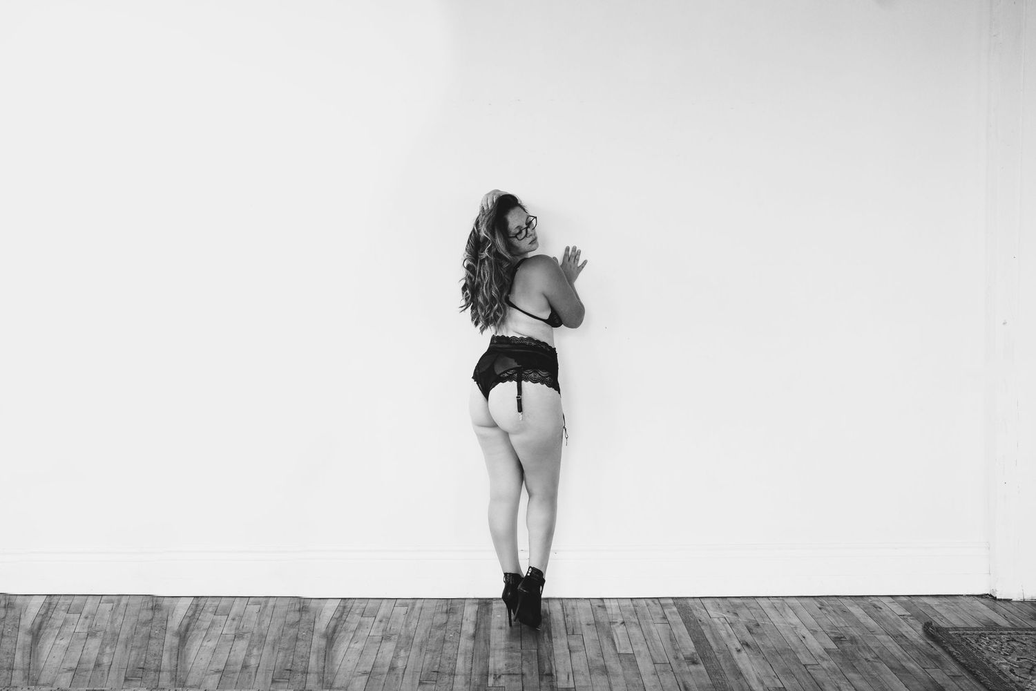 Black and white artistic photography series showing minimalist poses against light backgrounds.