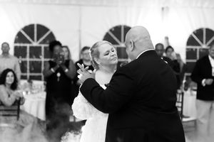 Black and white series of a romantic first dance moment at an indoor wedding reception.