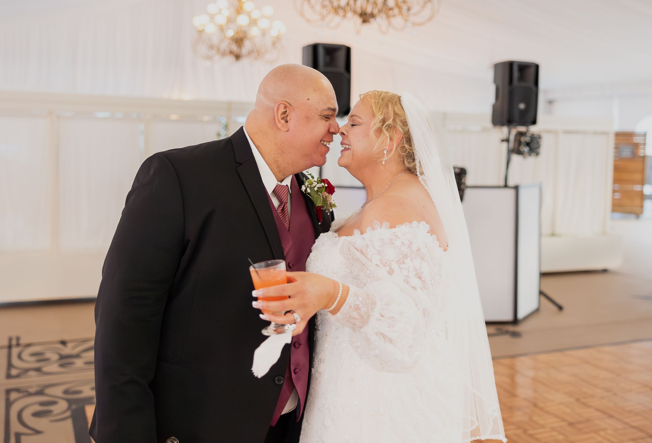 Romantic indoor wedding ceremony moments captured in bright white venue space.