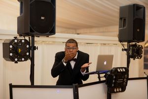 Professional audio and lighting equipment setup at an indoor wedding venue.