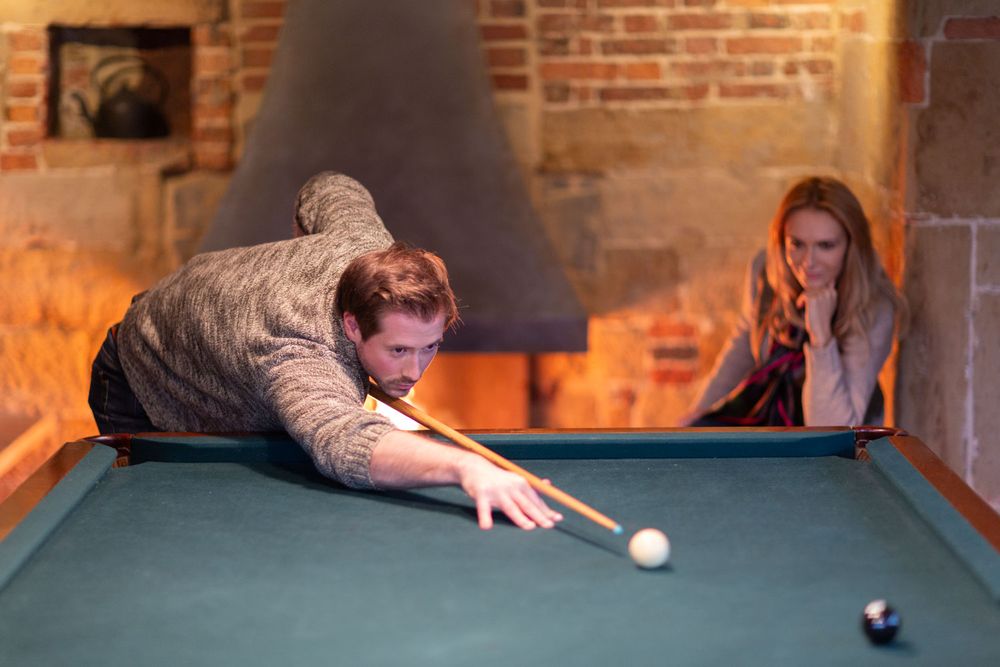 High-end lifestyle imagery of people playing snooker in a luxury Kent country house -2