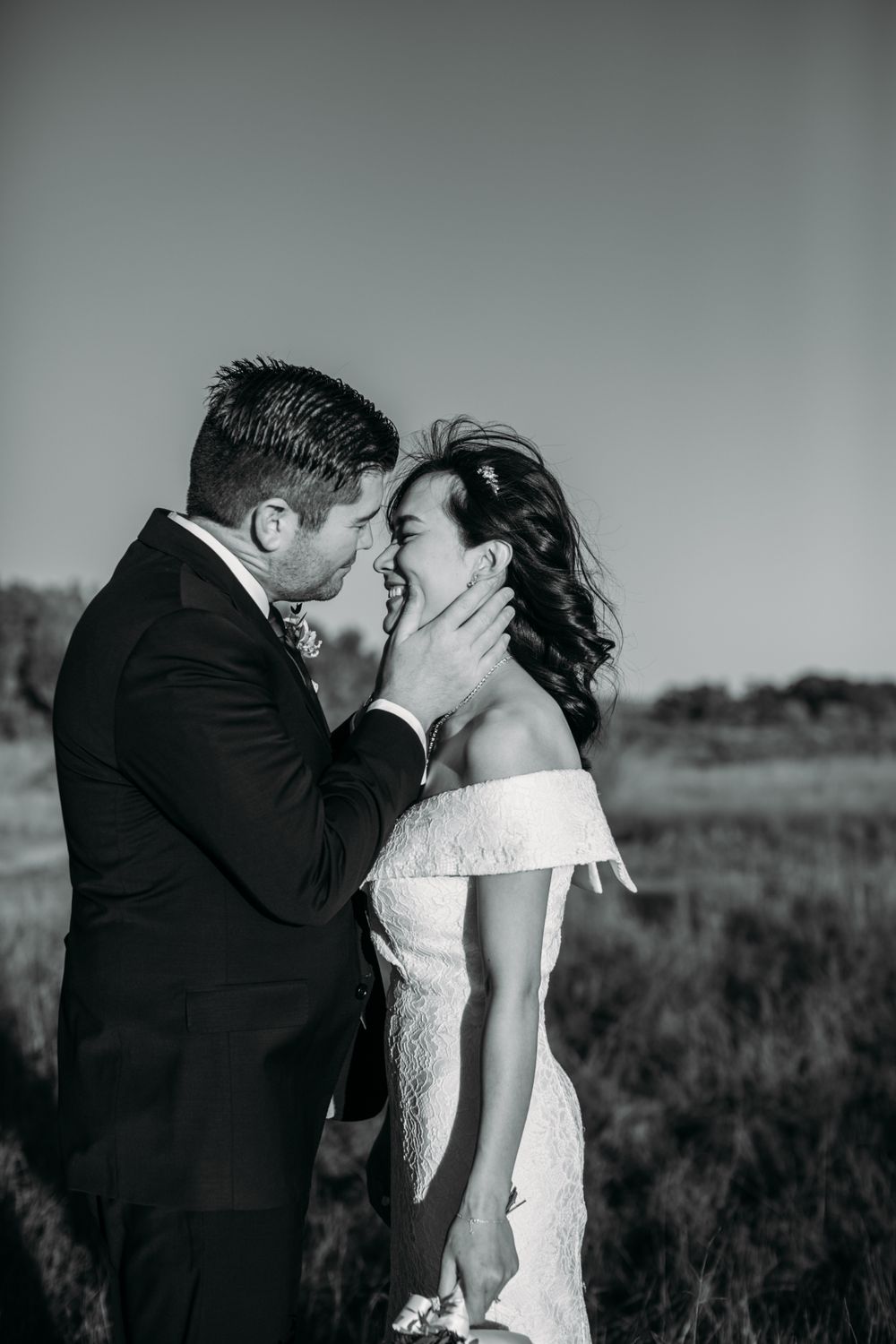 Black and white romantic portrait of a tender moment between newlyweds.