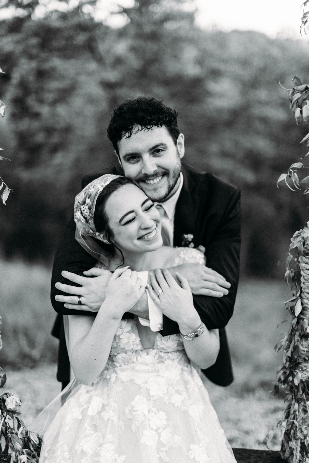 A joyful black and white portrait capturing a tender wedding moment.