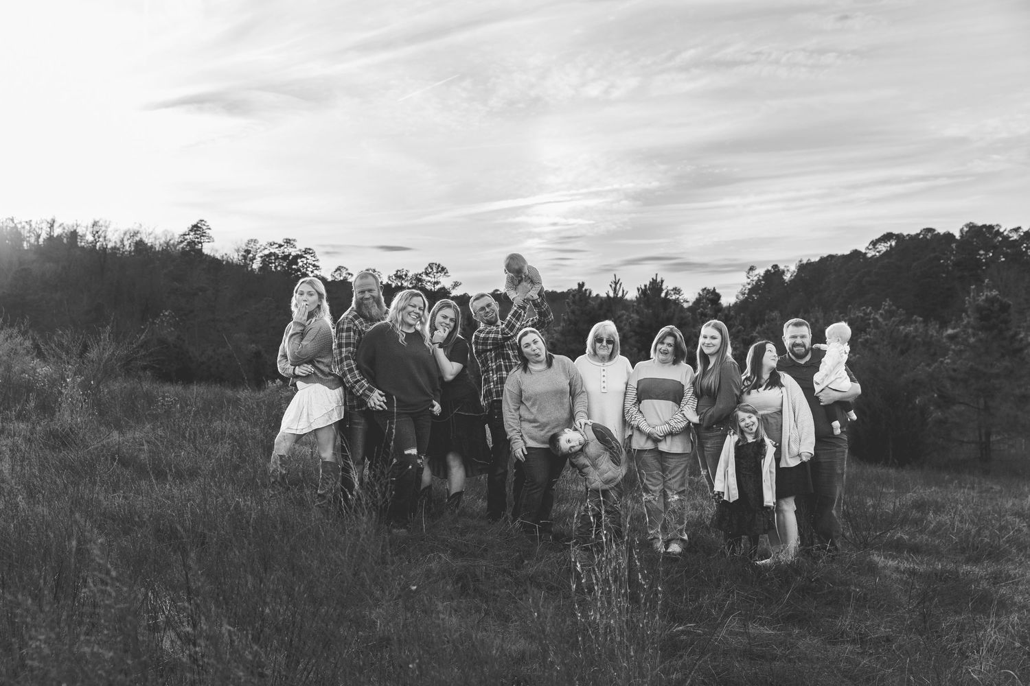 Large family group portrait in black and white with natural outdoor lighting.