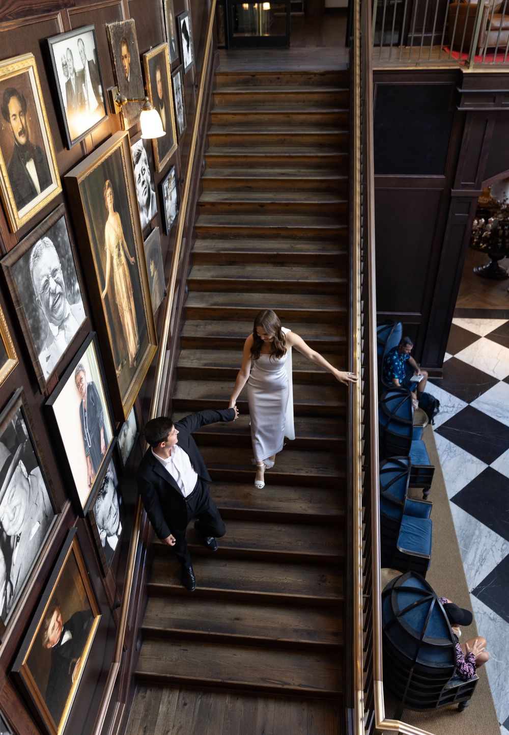 Orlando luxury wedding photographer bride being led by her mate down a fancy staircase.