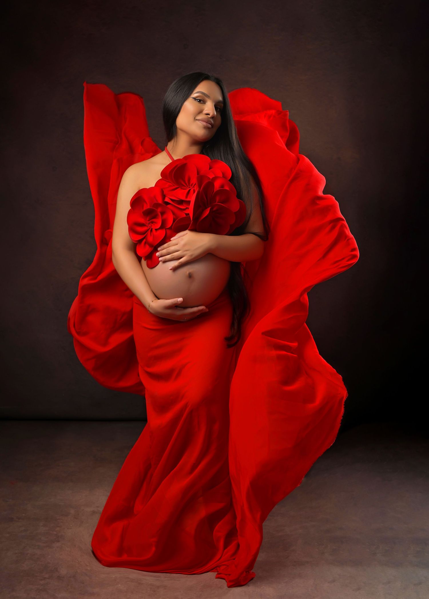 Elegant maternity photo featuring couple in powder blue tulle gown against white background.