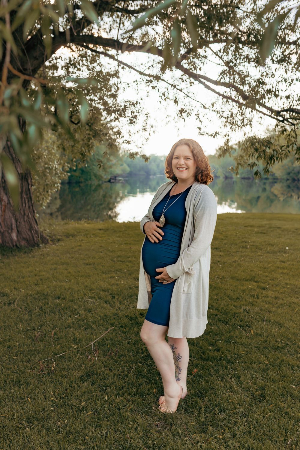 Expectant mom holding her baby bump during her outdoor maternity session in Wausau, Wisconsin