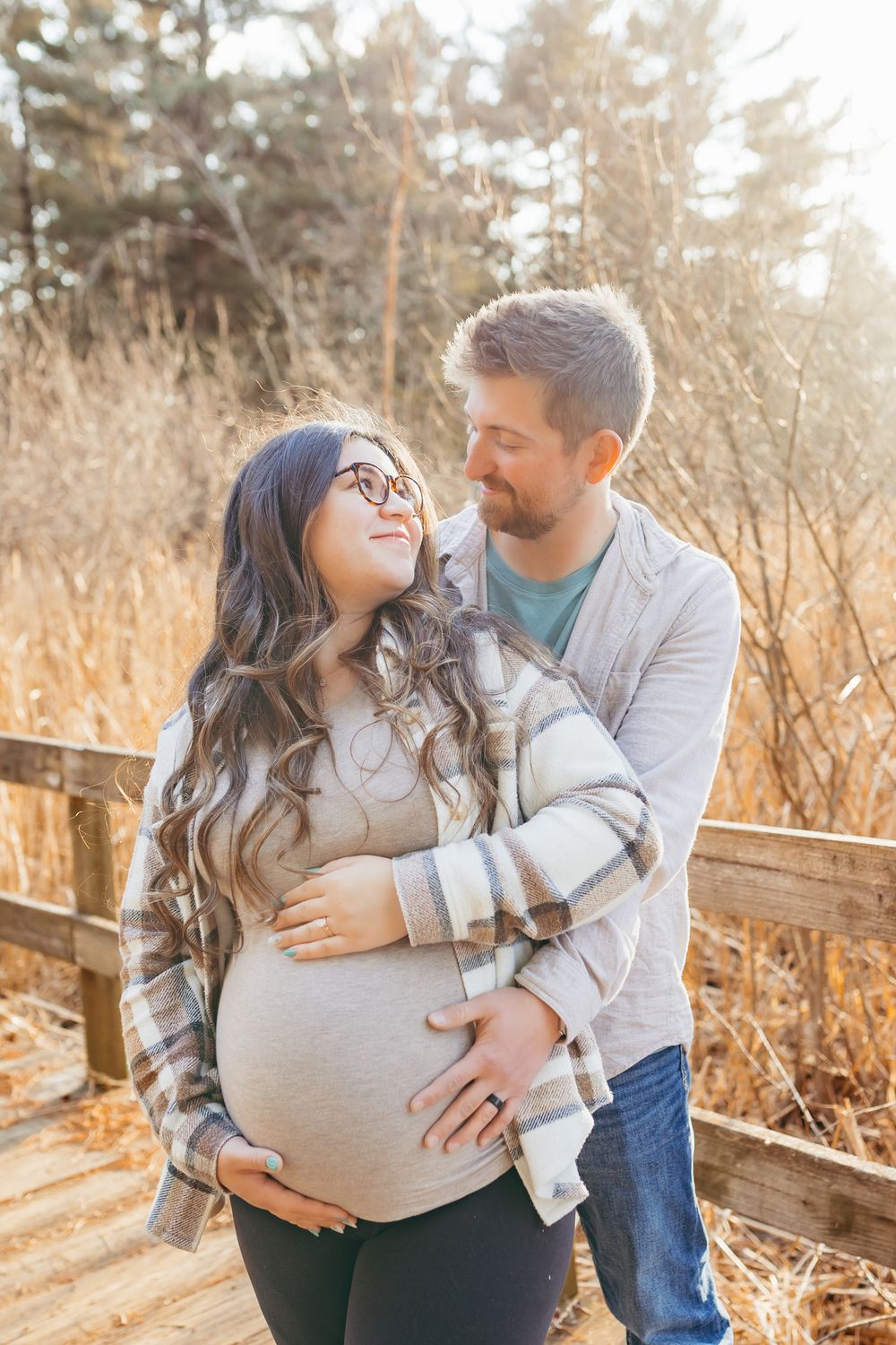 couple admiring each other during their relaxed maternity session in Wausau, Wisconsin