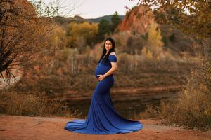 A flowing blue dress creates dramatic silhouettes against an autumn desert landscape at sunset.