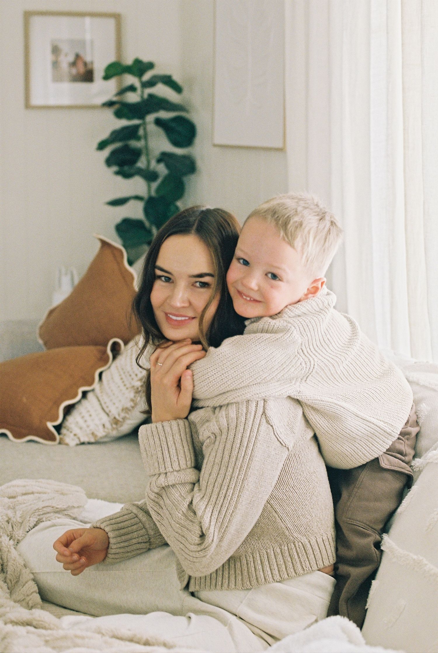 son cuddling mum on the couch captured on 35mm film