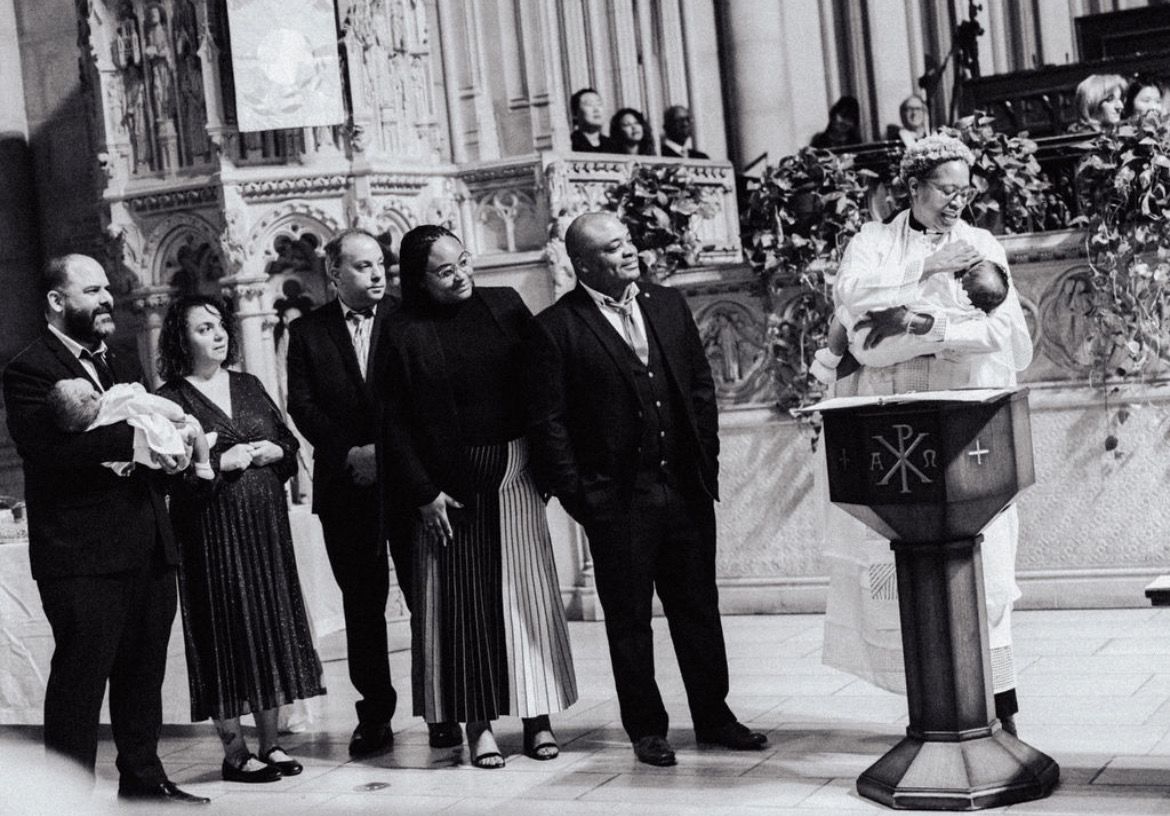 Vintage black and white photograph of a group gathering at a baptism.