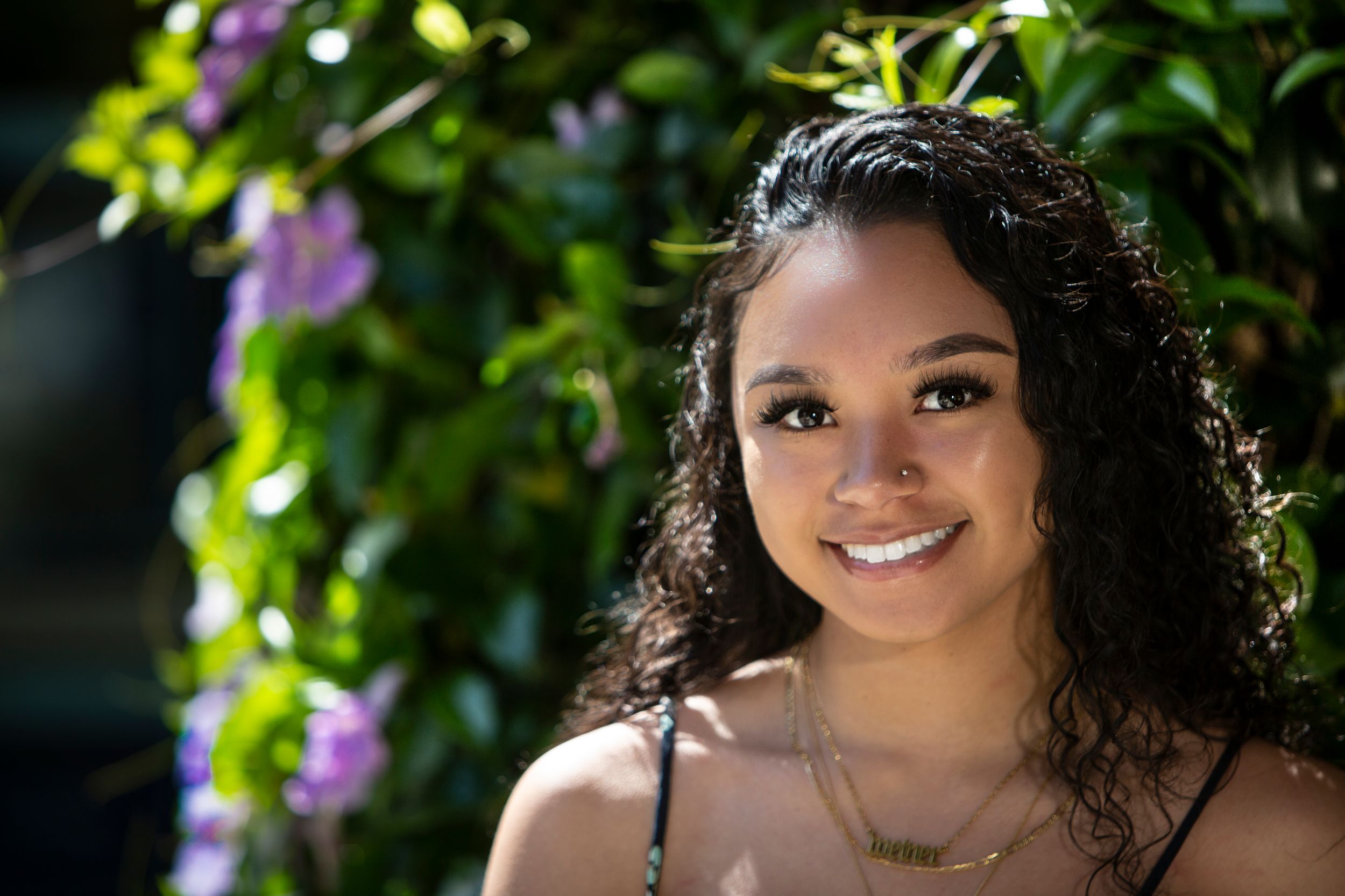 A series of outdoor portrait photos showing the same person in different poses with natural lighting and foliage backgrounds.
