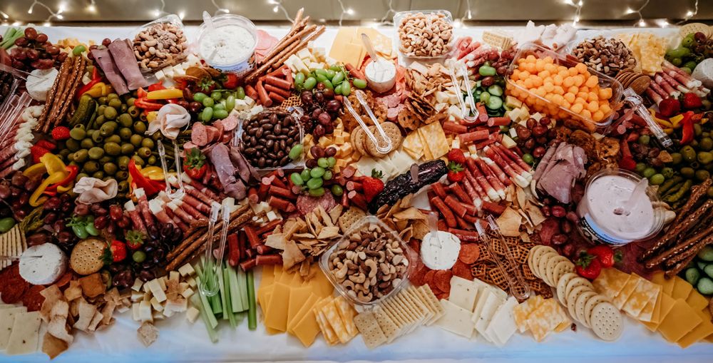 A close-up of an elaborate charcuterie spread with meats, cheeses, fruits and nuts.