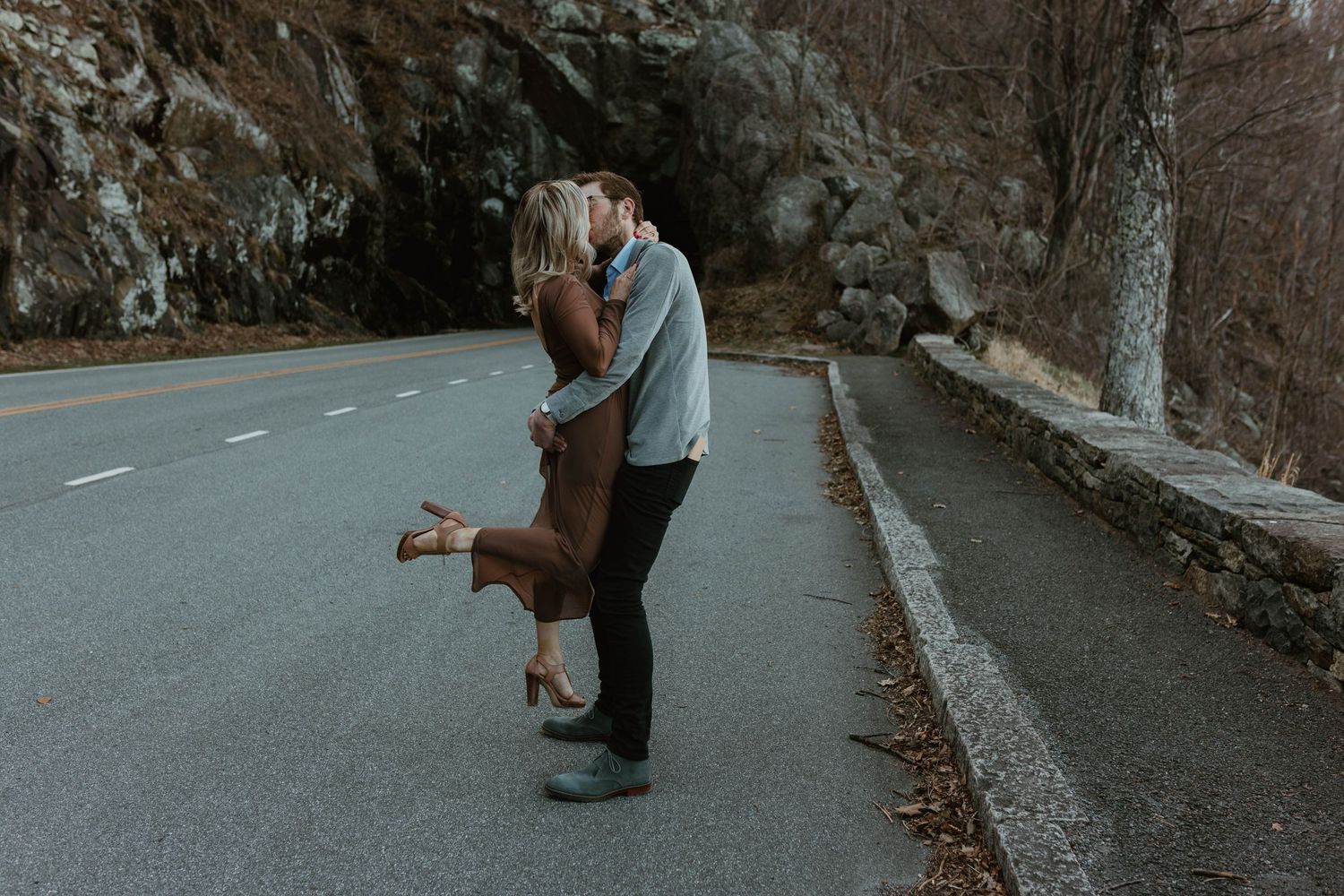 A series of silhouettes showing a couple on a mountain road at dusk.