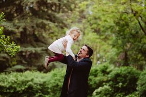 Playful family moments captured in a series of outdoor photos against a green natural backdrop.