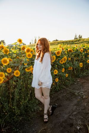 Ethereal portrait session in a blooming sunflower field at golden hour.