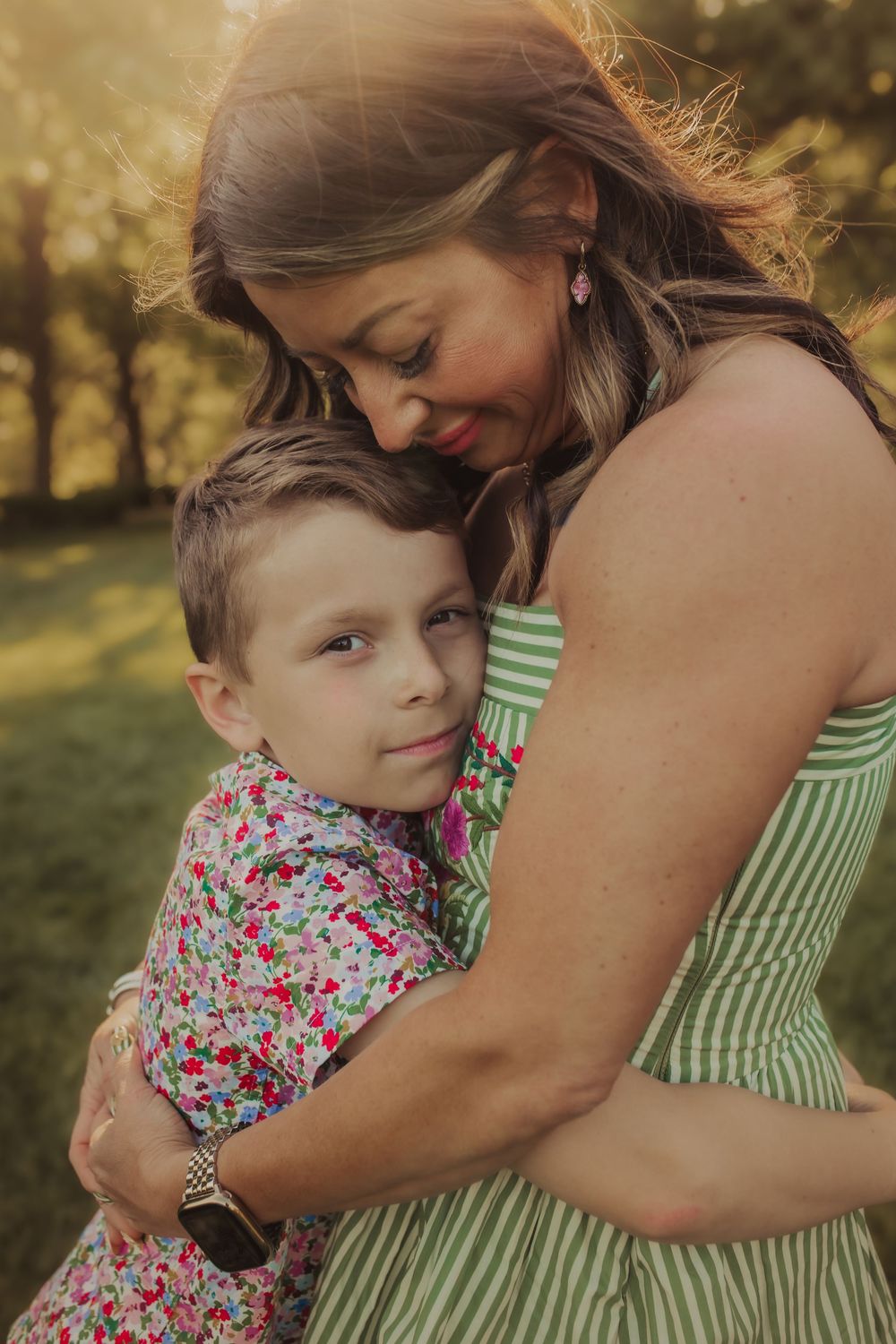 Mom holding son close during family session in Wimbledon