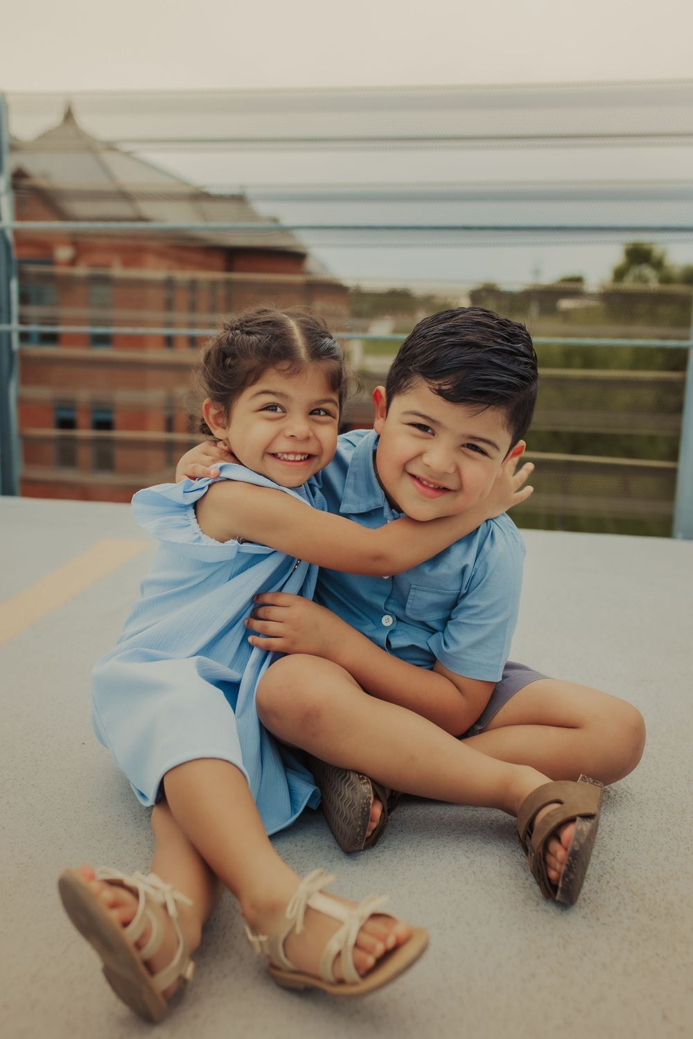Siblings laughing during family session in Wimbledon