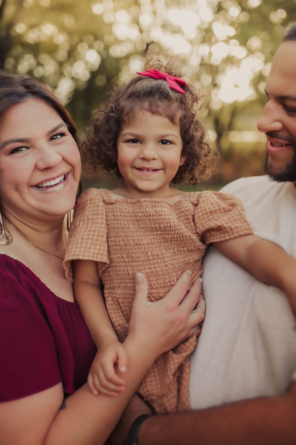 Family holding daughter close during family session in Wimbledon