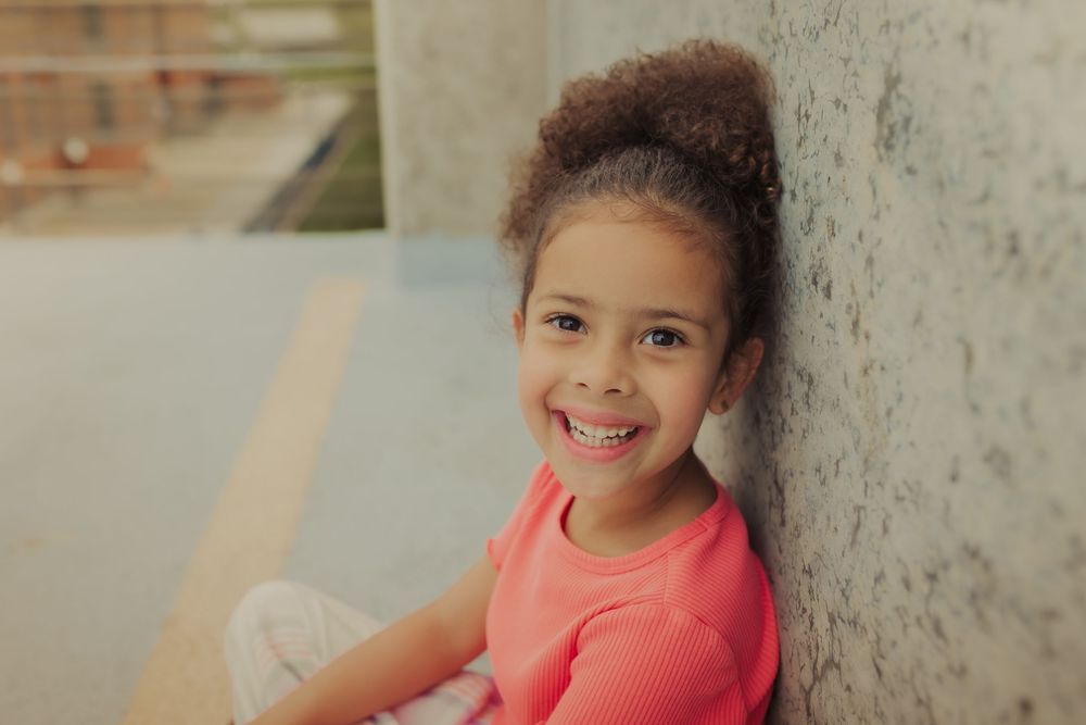 girl smiling during family session in Wimbledon