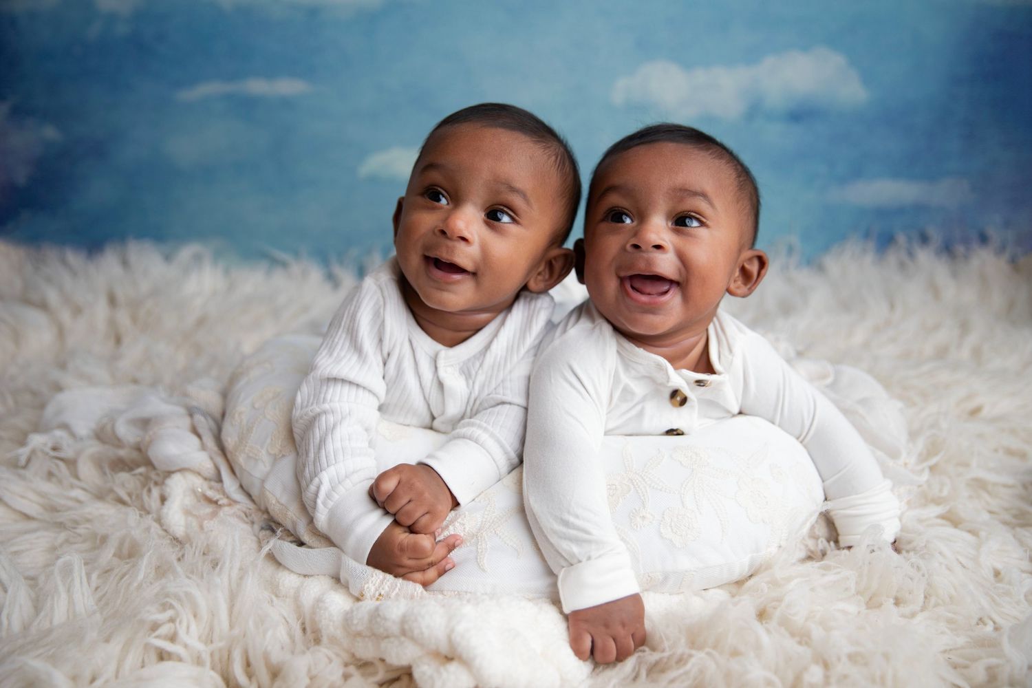 Twin babies smiling during newborn photography session in Orange City Florida.