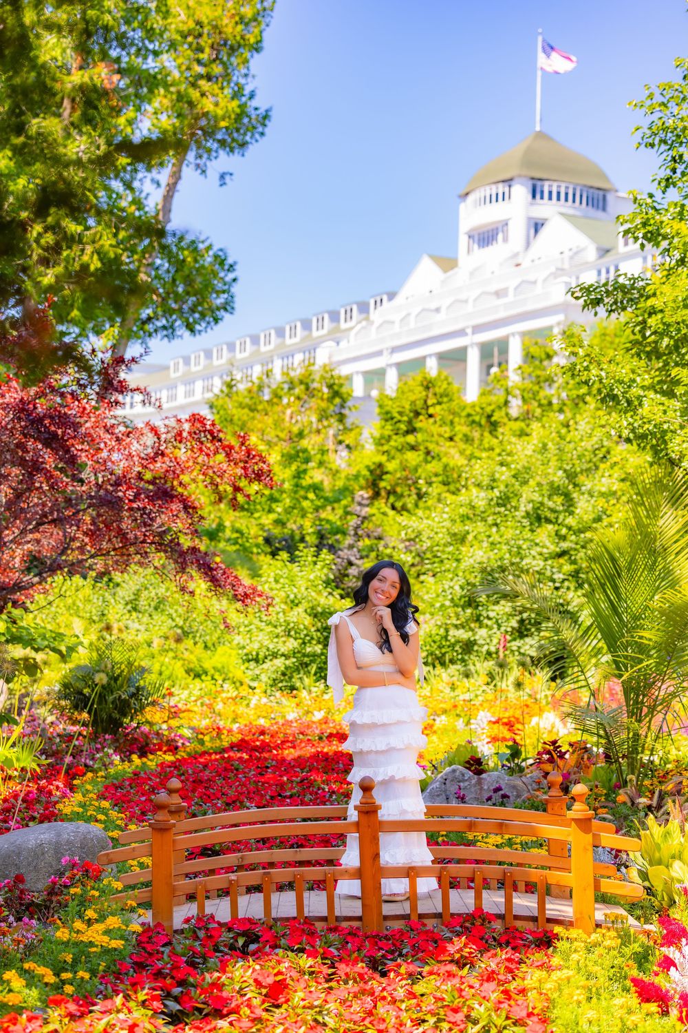 Romantic garden setting at Grand Hotel Mackinac Island with Japanese bridge surrounded by vibrant fall foliage.