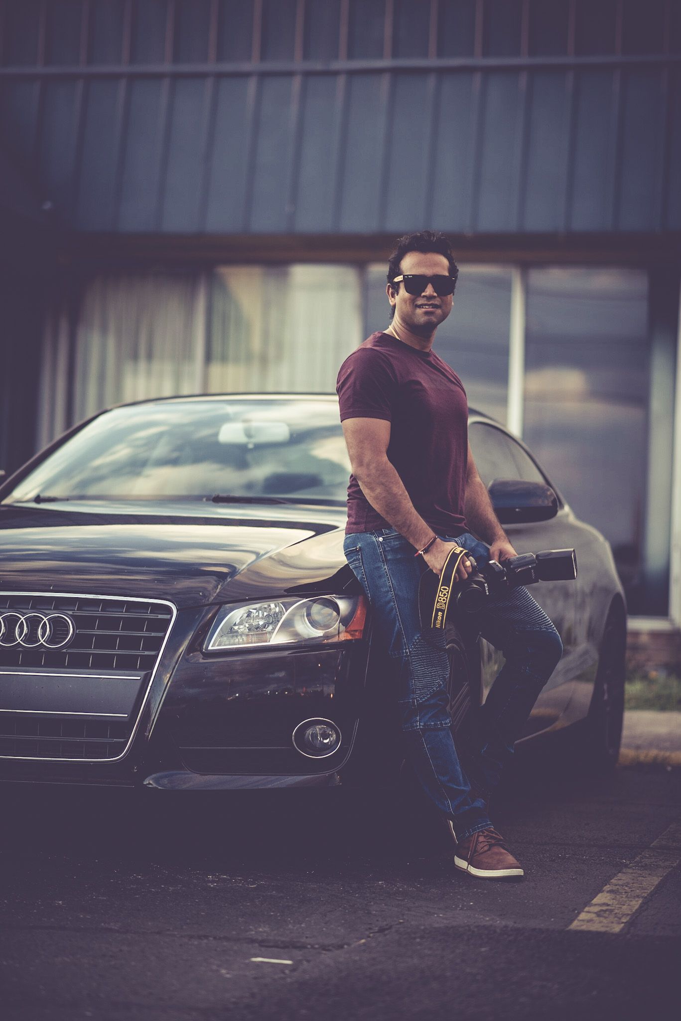 A sleek black Audi car photographed from multiple angles in a parking lot.