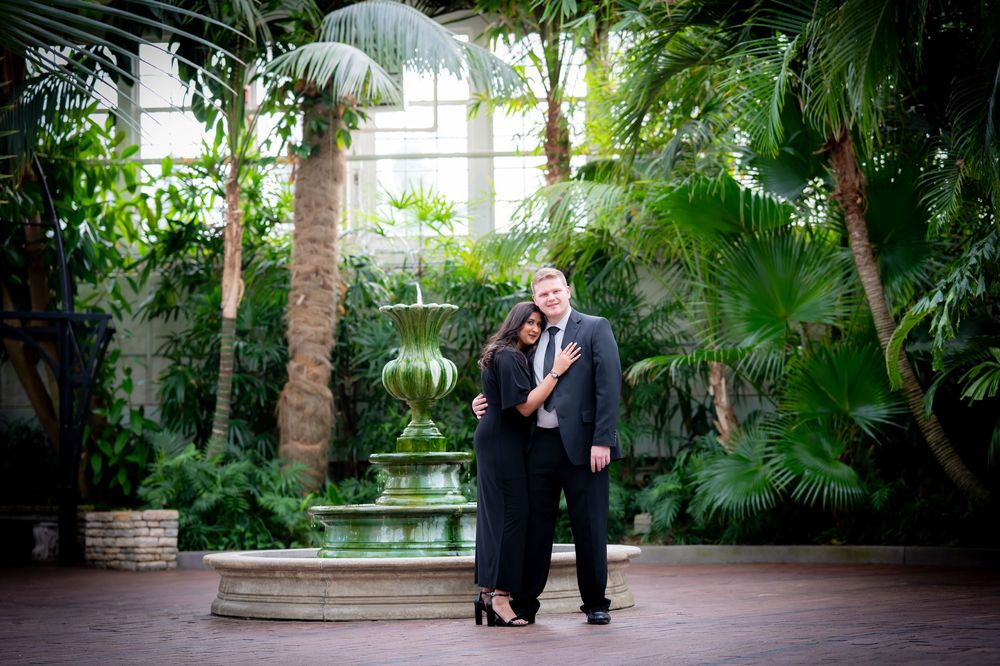 Indoor garden conservatory with lush tropical plants and stone walkways.