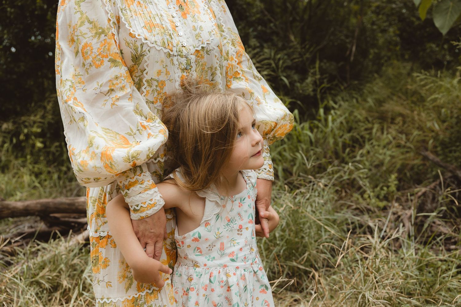 Mum and daughter splashing in the water during a family photo shoot in Brisbane